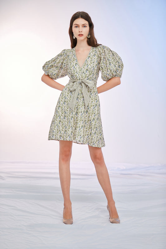 a woman in a dress holding a surfboard