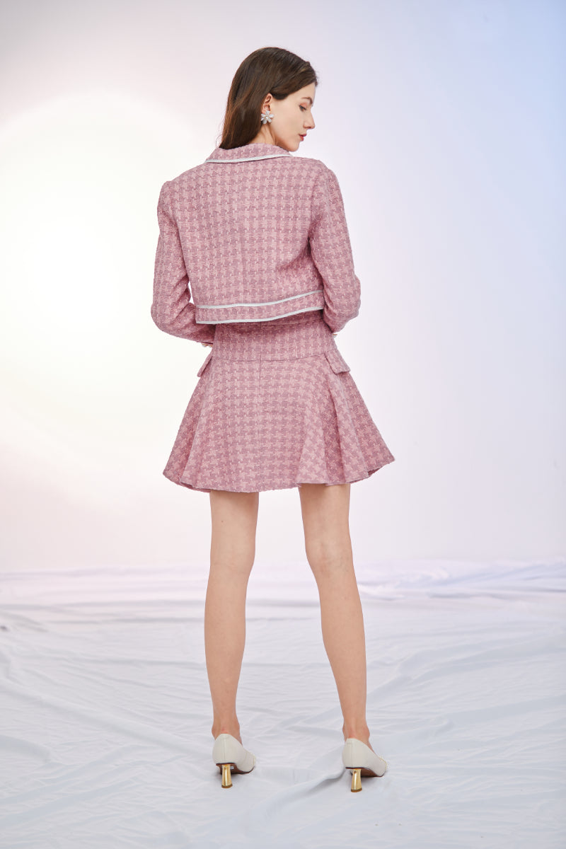 a woman in a pink dress standing on a beach