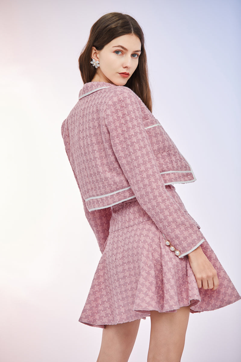 a woman in a pink dress holding a purse