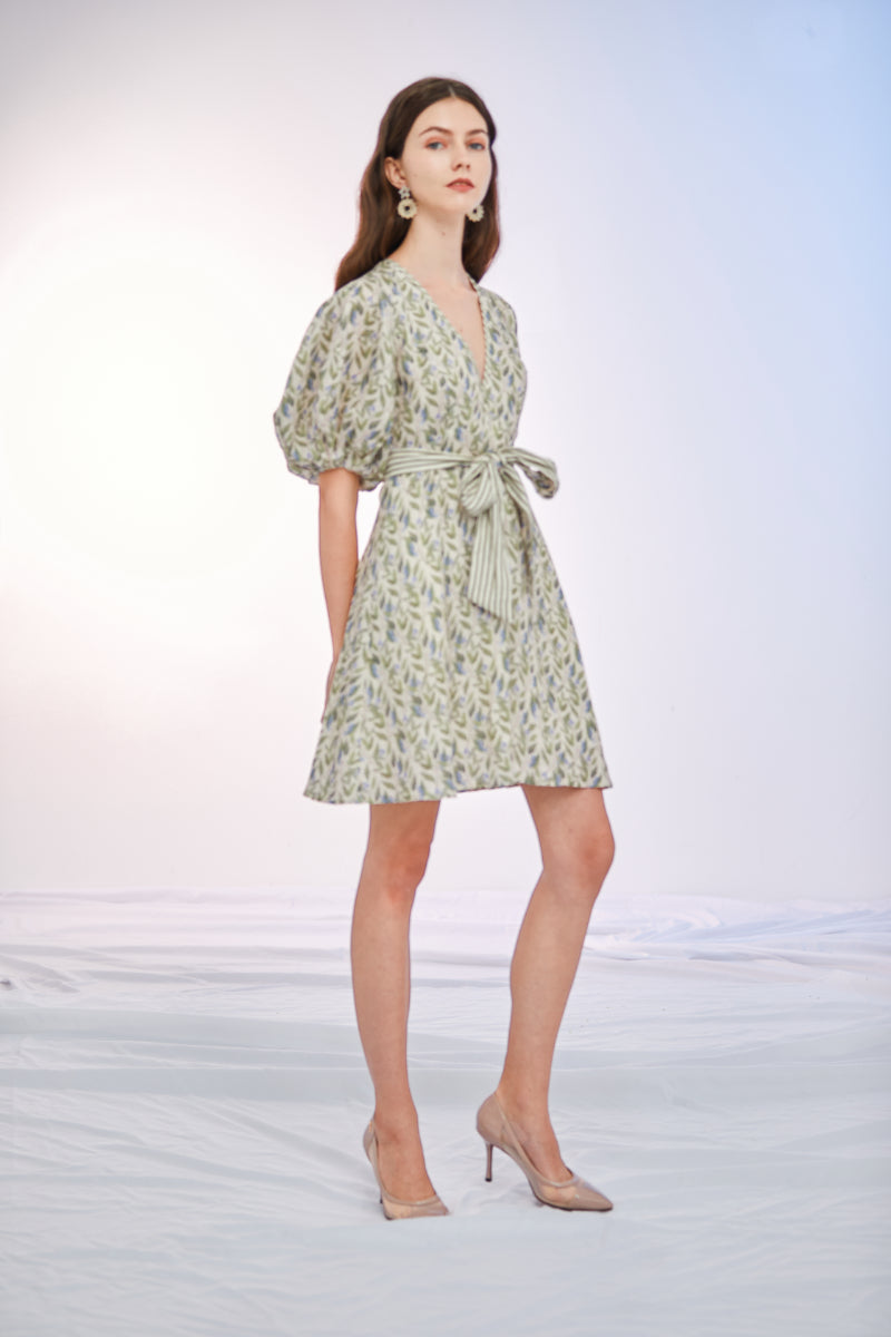 a woman in a dress holding a tennis racket