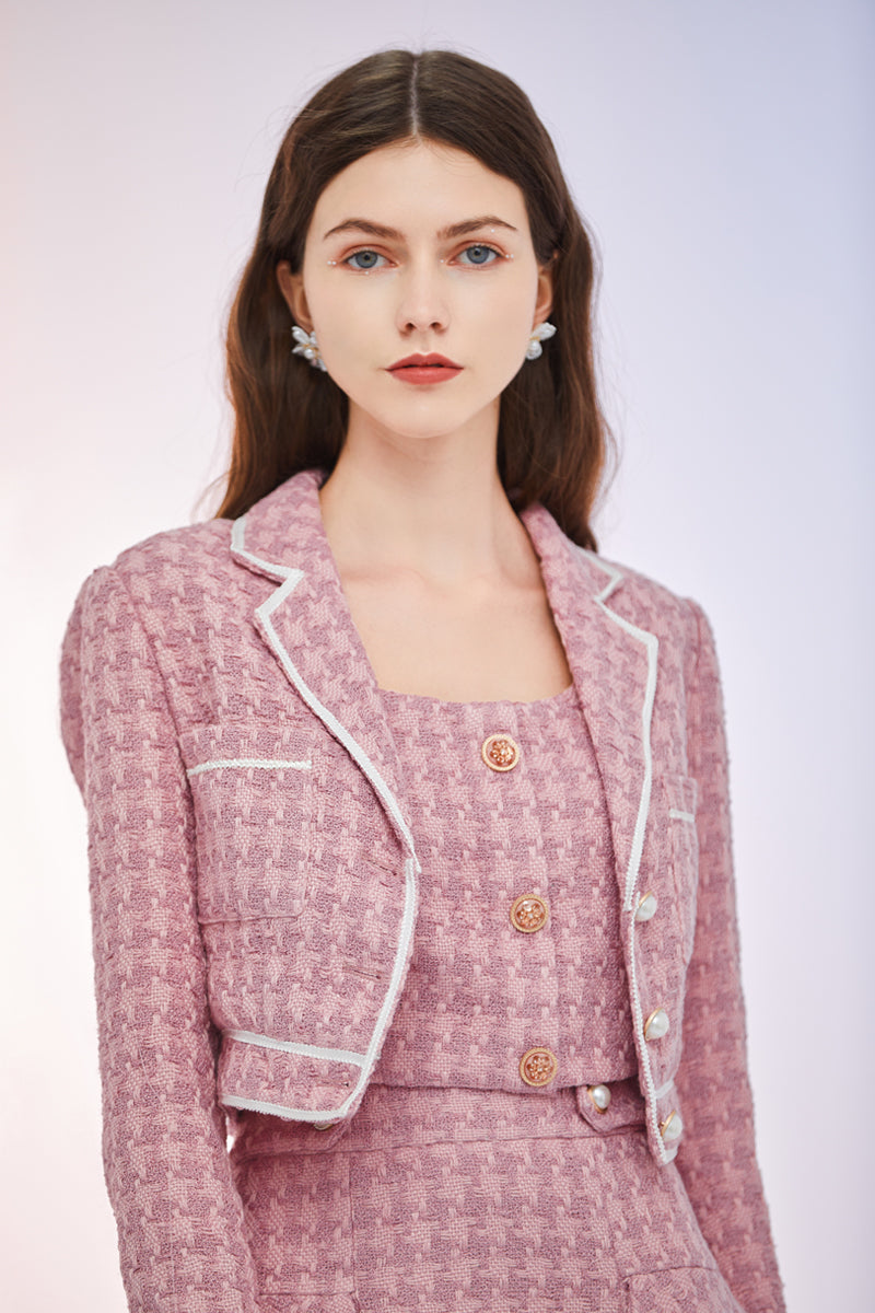 a woman in a pink dress holding a cell phone